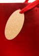 golden gift tag on red