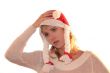 Young womanon cap of Santa thinking about New Year
