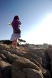 a woman standing on a rock