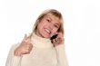 Smiling girl with mobile phone with good idea gesture