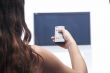 Woman with remote control and flat tv