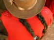 Latina with plaited hair and hat