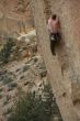 Climber on overhanging cliff route
