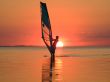 Silhouette of a windsurfer on waves of a gulf 4