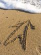 arrow on wet sea sand