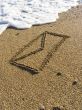 envelope on wet sea sand