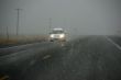 Traffic moving through fog