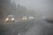 Traffic moving through fog