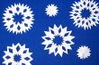 blu background with white papery snowflakes