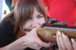 Female shooter taking aim close-up