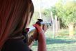 backside wiev of female shooter taking aim