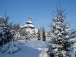 Winter snowy landscape with fur-trees and church