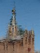 Church Cupola with Cross reflected in wavy water