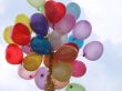 Set of colorful rubber balloons flies in blue sky