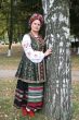 Young lady in Ukrainian costume near birch