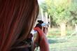 backside wiev of female shooter taking aim