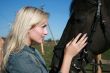 Blond female with brown horse close-up portrait