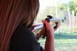 backside wiev of female shooter taking aim