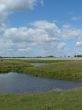 summer field with river uder cloudy deep sky