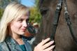 Blond female with brown horse close-up