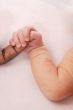 White hand holding black finger