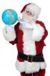 Santa Claus pointing at a globe
