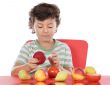 child playing with fruits