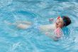 boy learning to swim