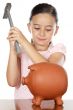 adorable boy breaking the money box