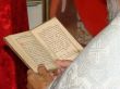 Opened Slavic Gospel in hands of orthodox priest