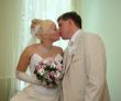 Wedding kiss of young newlyweds couple