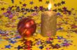 Gold candle and red glass ball