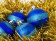 Christmas blue ornaments and gold tinsel