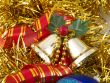 Christmas bells and ribbon on gold tinsel