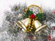 Christmas bells on silver tinsel background
