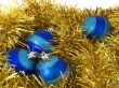 Christmas blue ornaments and gold tinsel