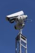 CCTV camera against blue sky