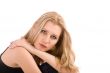Portrait of blond in black dress over white
