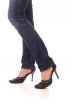 Woman legs dressed in jeans and black shoes walk forward