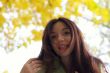 Woman peek from above on camera in autumn park