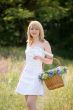 Sexy girl walk with basket on meadow