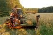 man operates an old tractor
