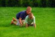 two boys play on the grass
