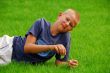 young boy is resting on the grass