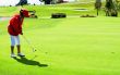 Lady in red jacket putting