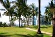 Tropical seaside resort hotel building with palm trees