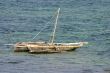 A small wooden boat anchored in the bay
