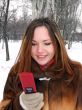 The girl in the winter in park with phone