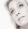 Studio portrait of a long blond girl looking up