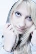 Studio portrait of friendly looking a long blond girl